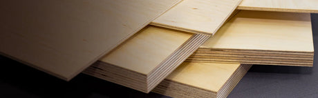 Planches de contreplaqué bois clair empilées, idéales pour ébénisterie et menuiserie.
