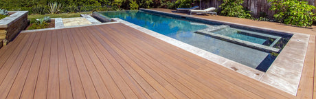 Terrasse en composite brun autour d'une piscine moderne, idéale pour l'aménagement extérieur